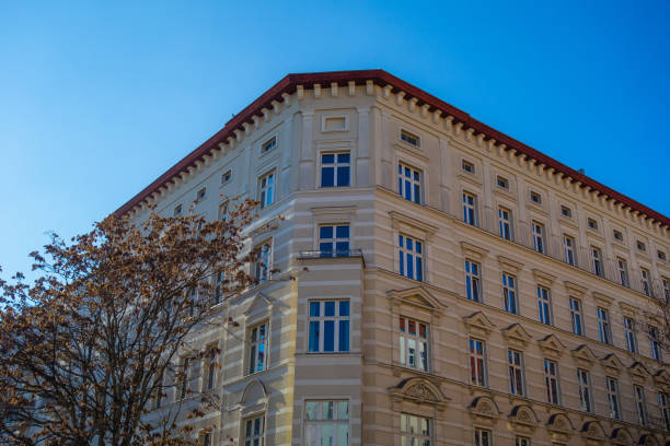 istock yellow corner building with darken blue sky 1150548112