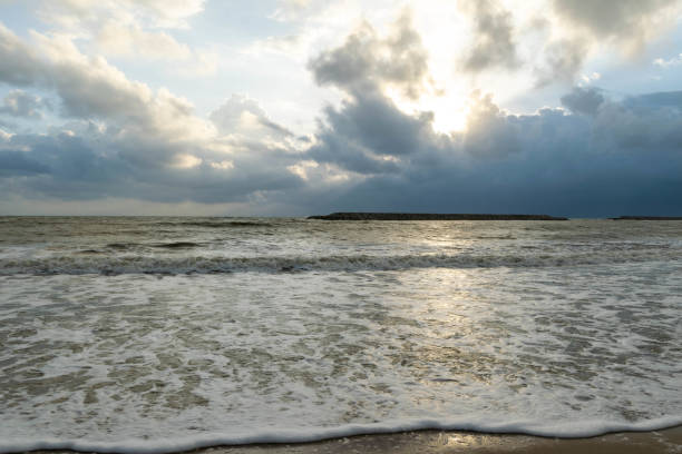 istock Sand, sea and clouds at sunrise 1150548415