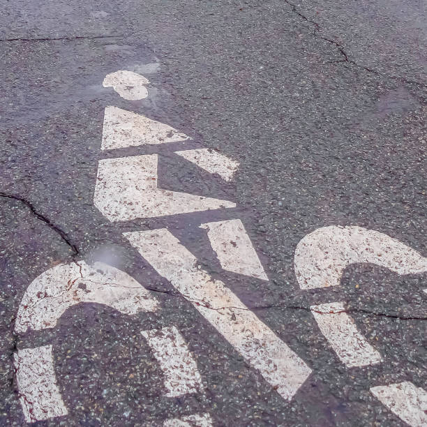 istock Clear Square Bicycle lane sign painted on a road with cracks 1150549171