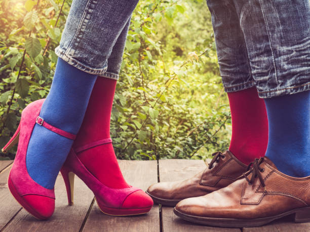 istock Men's and women's legs, bright socks. Close-up 1150549515