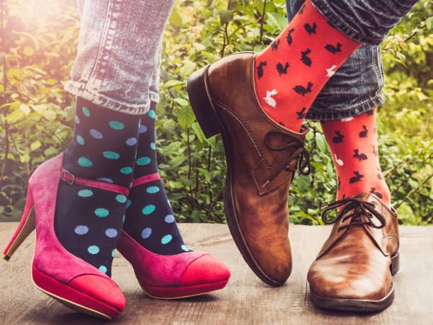 istock Men's and women's legs, bright socks. Close-up 1150549539