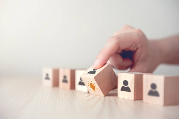 istock Leader with idea and innovation, Woman hand flips cube with icon light bulb and human symbol. 1150549895