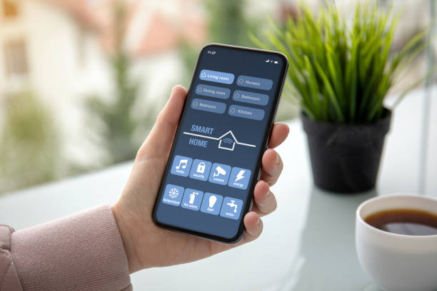 istock female hand holding phone with app smart home on screen 1150552890