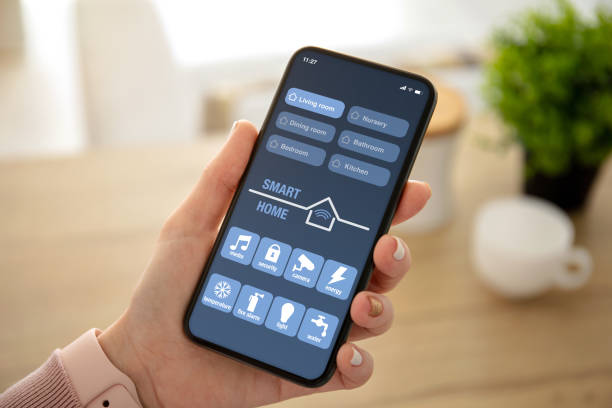 istock female hands holding phone with app smart home on screen 1150552987