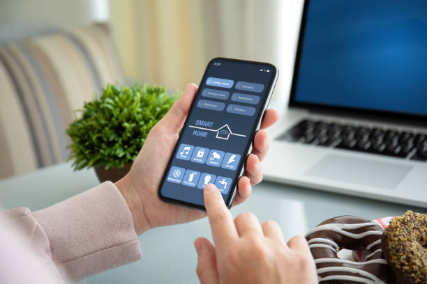 istock female hands holding phone with app smart home on screen 1150553108