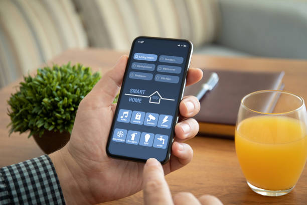 istock male hands holding phone with app smart home on screen 1150553233