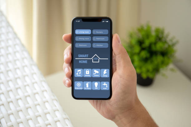 istock man hand holding phone with app smart home on screen 1150553268