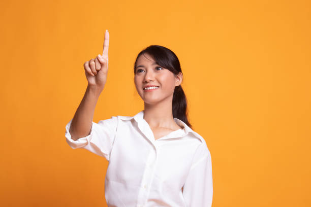 istock Asian woman touching the screen with finger. 1150554588