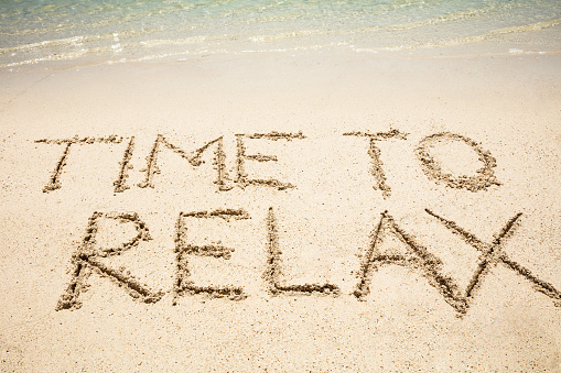 Time To Relax Text Written On Sand Near The Coast At Beach