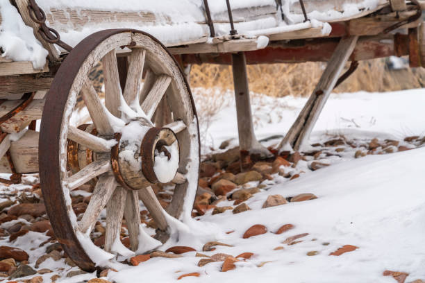 istock An old wooden wagon with rusty wheels dusted with snow in winter 1150556751