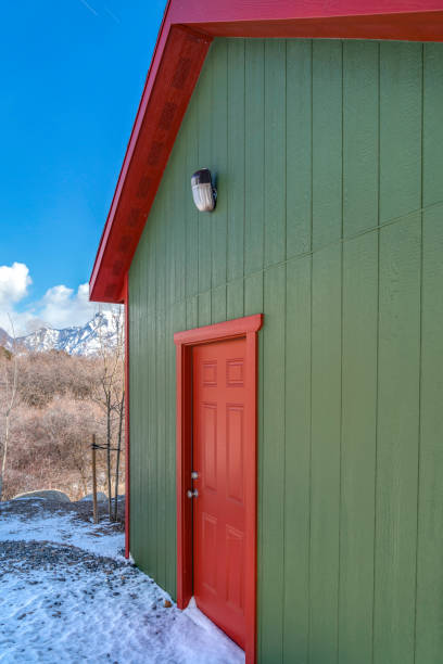 istock Storage shed against trees and snow capped mountain under cloudy blue sky 1150556765