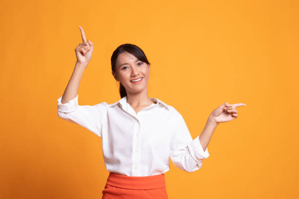istock Young Asian woman point with two hands. 1150557752