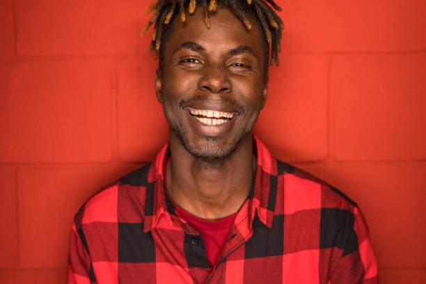 istock Portrait of a cheerful man on red 1150557890