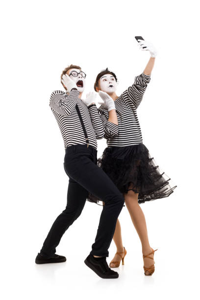 Smiling mimes in striped shirts.
