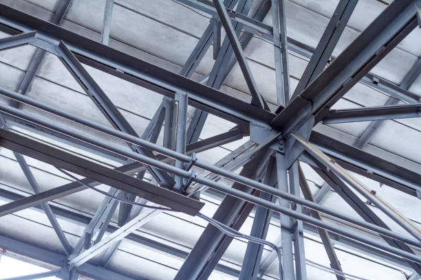 istock Perspective from the bottom to the frame roof of a warehouse or workshop 1150560355