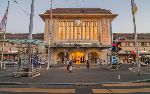 Switzerland - Lausanne - The massive art deco building of main Lausanne railway staition with clock and entrance arches on Terminal square (or place de la gare)