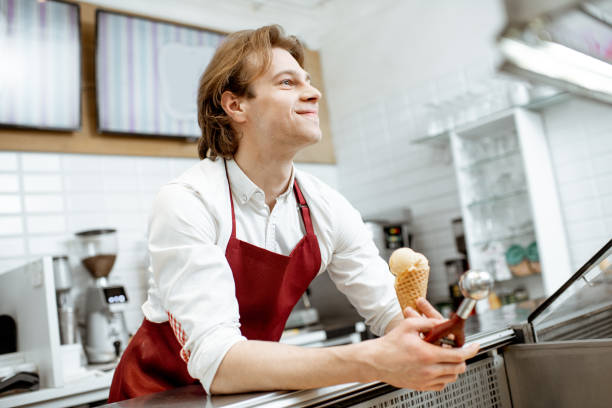 istock Man selling ice cream in the shop 1150561692
