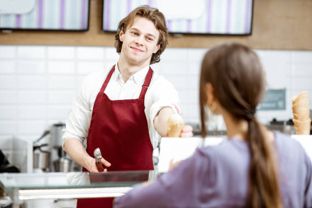 istock Man selling ice cream in the shop 1150561789