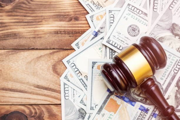Gavel with money on wooden background. Space for text. Toned image. stock photo