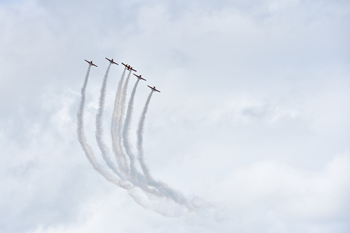 Gelendzhik, Russia - september 9, 2018: Airshow of the Russian aerobatic team on piston aircraft with propellers against a rainy sky with clouds. The name of the event is hydroaviasalon. It takes place once every two years.