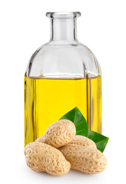 Peanuts with leaves and peanut oil in bottle stock photo