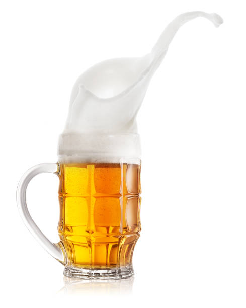 istock Splash of light beer in faceted mug 1150568309