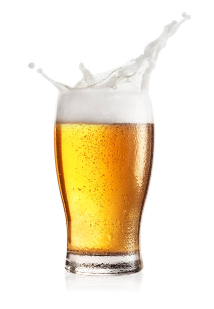 Steamed glass of light beer with splash stock photo