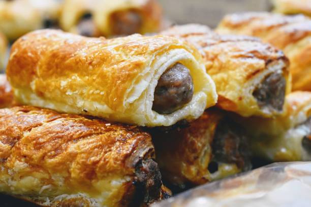 Sausage rolls Pork and sage sausage rolls baked in a golden puff pastry SAUSAGE ROLL stock pictures, royalty-free photos & images