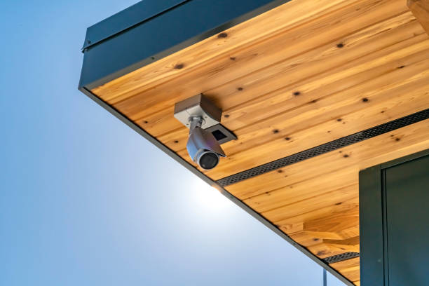 istock Home with security camera installed on the wooden underside of its roof 1150568945