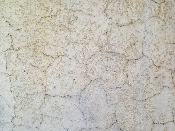 istock cream colored vintage concrete wall painted, big cracks 1150569861