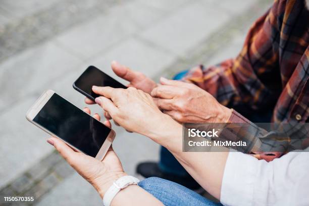 Charge Sharing Stock Photo - Download Image Now - Active Seniors, Adult, Adults Only