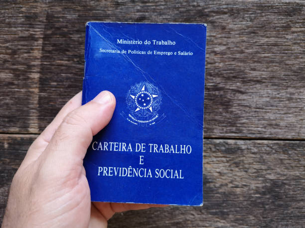 istock Hand holding Brazilian document work and social security with wooden background 1150571074