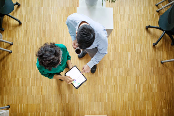 istock Business people reviewing statistical report on tablet pc 1150572088