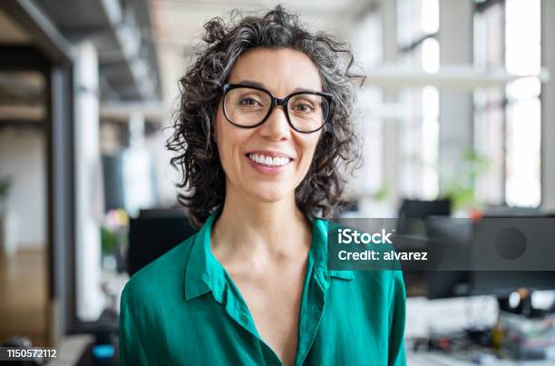 Closeup Of A Smiling Mid Adult Businesswoman Stock Photo - Download Image Now - Women, Headshot, One Woman Only