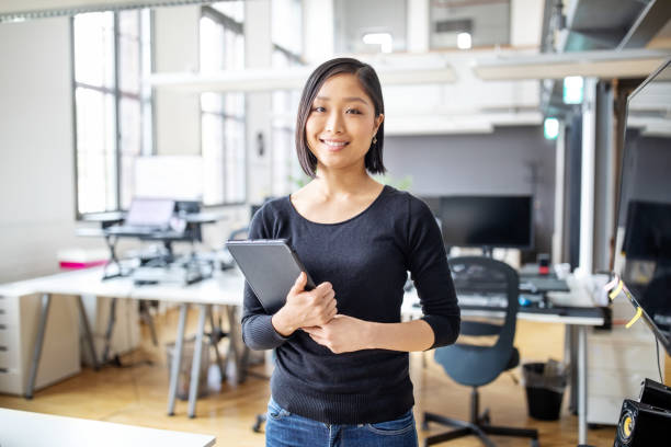 istock Smiling female executive with digital tablet. 1150572152