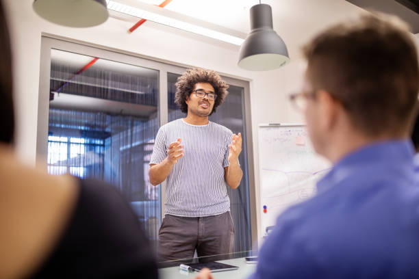 istock Male professional giving presentation to team 1150572158