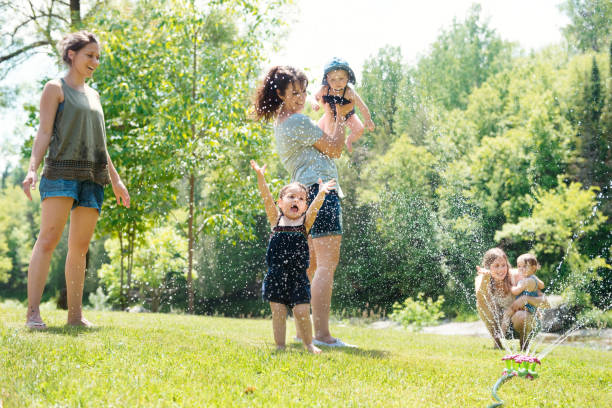 istock Millennial family playing with sprinkling water 1150573307
