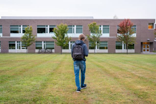 istock Student walking through a soccer field. 1150573400