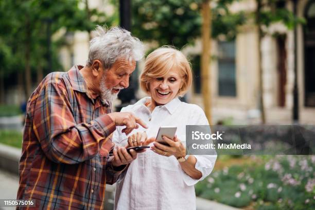 Charge Sharing Stock Photo - Download Image Now - Active Seniors, Adult, Adults Only