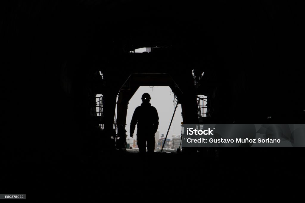The silhouette of two people in a high-speed railway tunnel under construction The silhouette of a person in a high-speed railway tunnel under construction. Abstract Stock Photo