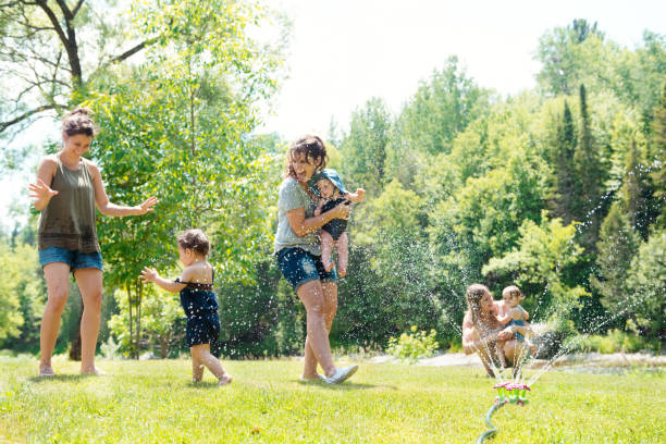 istock Millennial family playing with sprinkling water 1150575975