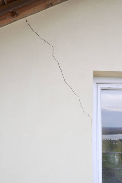 istock plaster wall with cracks. Building requiring repair .closeup. 1150576435
