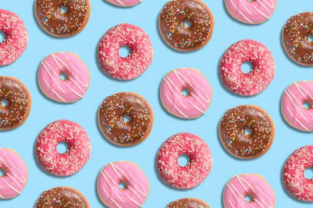 istock Colorful donut pattern on pastel blue background. Creative minimal summer concept. 1150576640