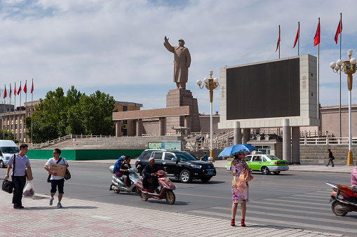 Kashgar, Xinjiang, China - August 14, 2012: View of an avenue in the city of Kashgar with a statue of Mao Zedung, Xinjiang, China