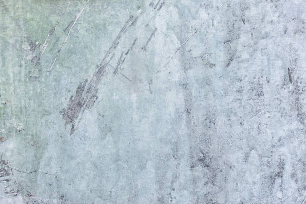 istock Light blue putty. Old plastered wall with stains and scratches. Decorative coating with an uneven texture. Blank background for layouts. 1150577565