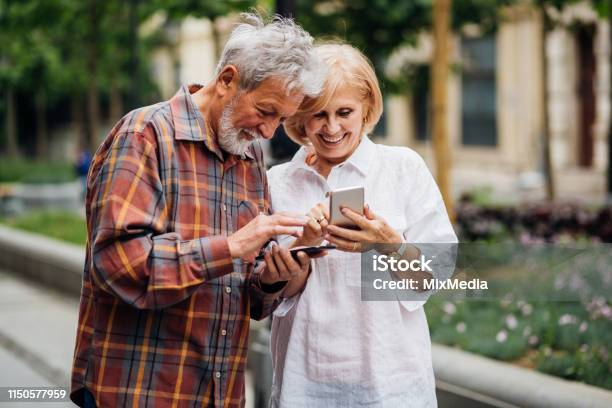 Charge Sharing Stock Photo - Download Image Now - Active Seniors, Adult, Adults Only