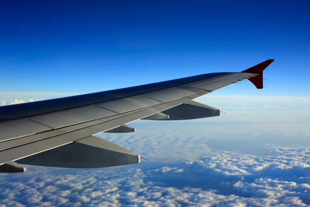 istock Wing of the plane on a background of clouds 1150579783