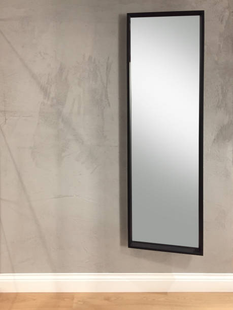 Rectangle mirror (clipping path) hanging on concrete wall with wooden floor Rectangle mirror (clipping path) hanging on concrete wall with wooden floor mirror object stock pictures, royalty-free photos & images