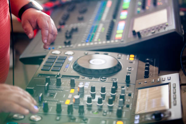 istock Close up of DJ hands mixing music on a table. 1150580235