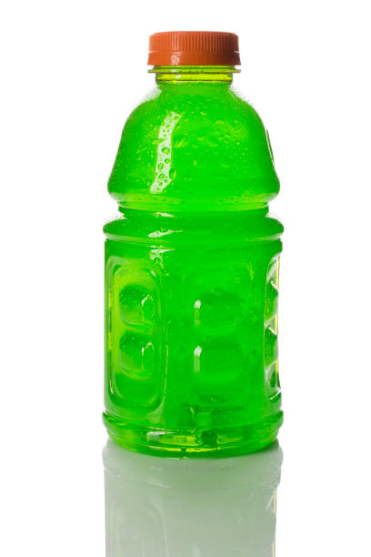 A bottle of a green colored sports or energy drink with water droplets, isolated on white with reflection.